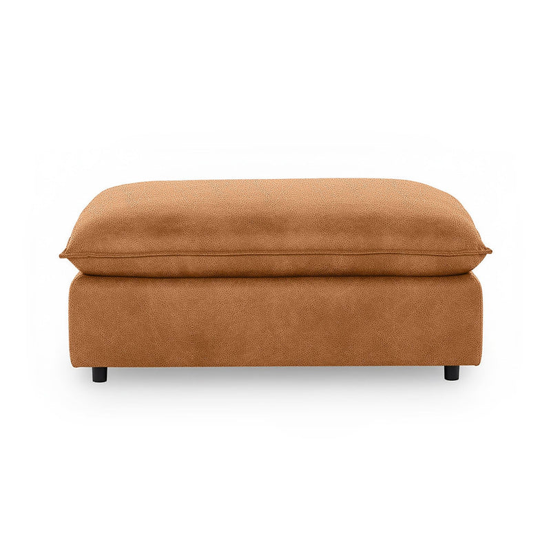Classic Home Caplan upholstered ottoman with a plush fabric cushion and wooden legs, perfect for living room decor.