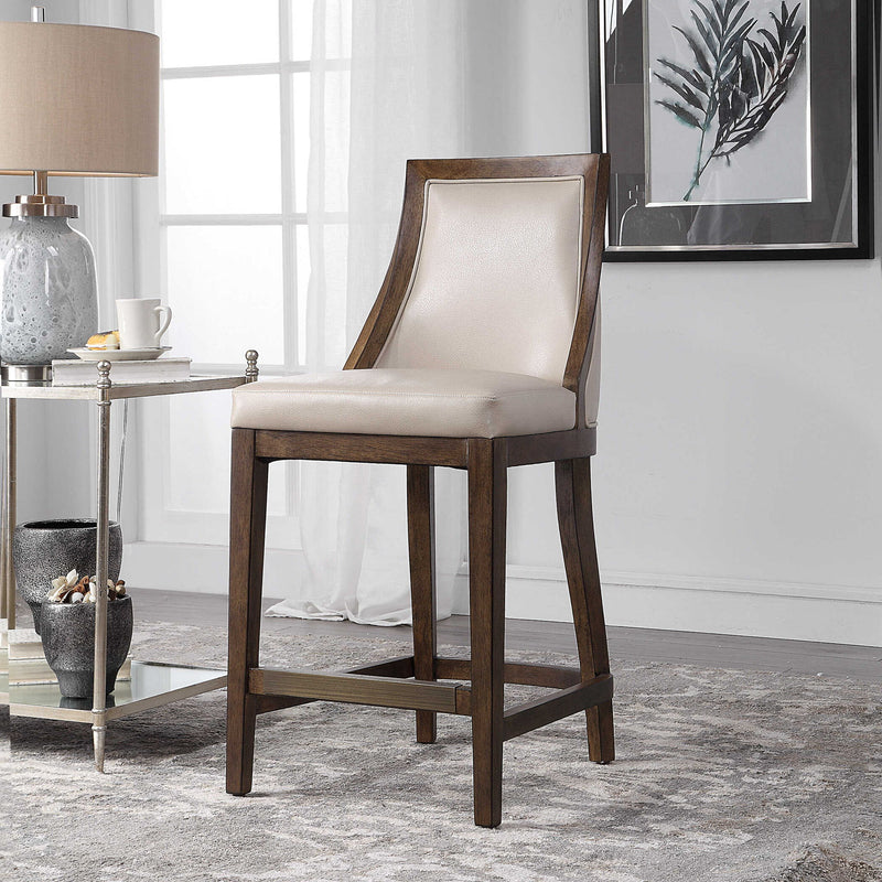 Uttermost Purcell beige counter stool with wooden legs and padded seat, suitable for kitchen or bar counter height.