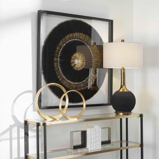 Uttermost Sandara Shadow Box wall decor in black and gold with layered geometric design on a neutral background.