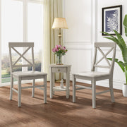 Pair of Noble House Plethora dining chairs with X-shaped backs, set of two, featuring wooden legs and cushioned seats.