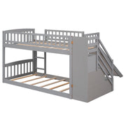 Gray twin over twin bunk bed with built-in stairway, two drawers, and slide by DreamHaus, showing the bed's stair access and storage features.