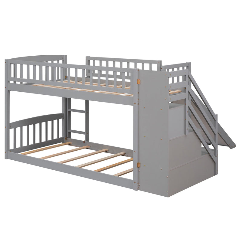 Gray twin over twin bunk bed with built-in stairway, two drawers, and slide by DreamHaus, showing the bed's stair access and storage features.
