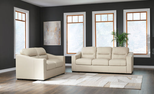 Signature Design by Ashley almond stationary sofa and loveseat set, featuring plush cushions and fabric upholstery.