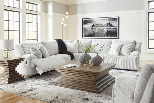 Six-piece Signature Design by Ashley reclining living room set with sofa, loveseat, and armchairs in neutral fabric.