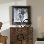 Framed black and white horse print with dark brown frame by Uttermost, showcasing detailed equine artwork on paper.