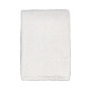 Classic Home Taiga throw blanket with soft, textured fabric in earthy tones, perfect for cozying up on the sofa.
