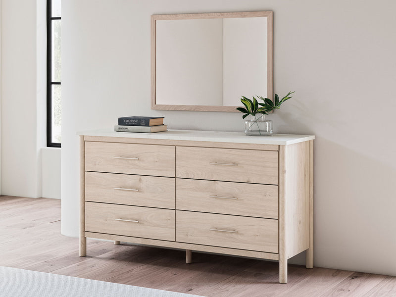 Signature Design by Ashley bedroom mirror featuring a sleek, rectangular design with a polished wood frame and reflective glass surface.