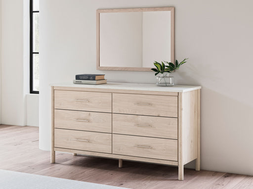 Signature Design by Ashley bedroom mirror featuring a sleek, rectangular design with a polished wood frame and reflective glass surface.