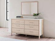 Signature Design by Ashley six-drawer dresser with dark wood finish and sleek metal handles, featuring ample storage drawers.