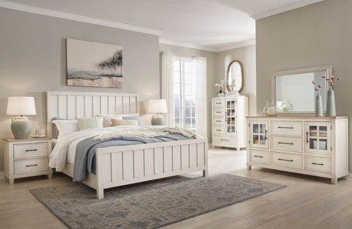 Benchcraft® Shaybrock panel bedroom set with a bed, two nightstands, dresser, and mirror in a modern bedroom display.