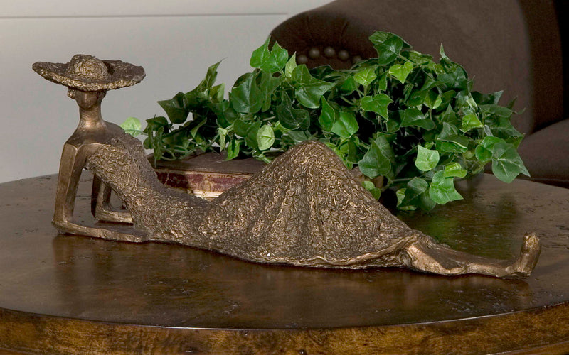 Antique bronze sculpture titled Summer Days by Uttermost, featuring a detailed figurine with a warm, textured finish.