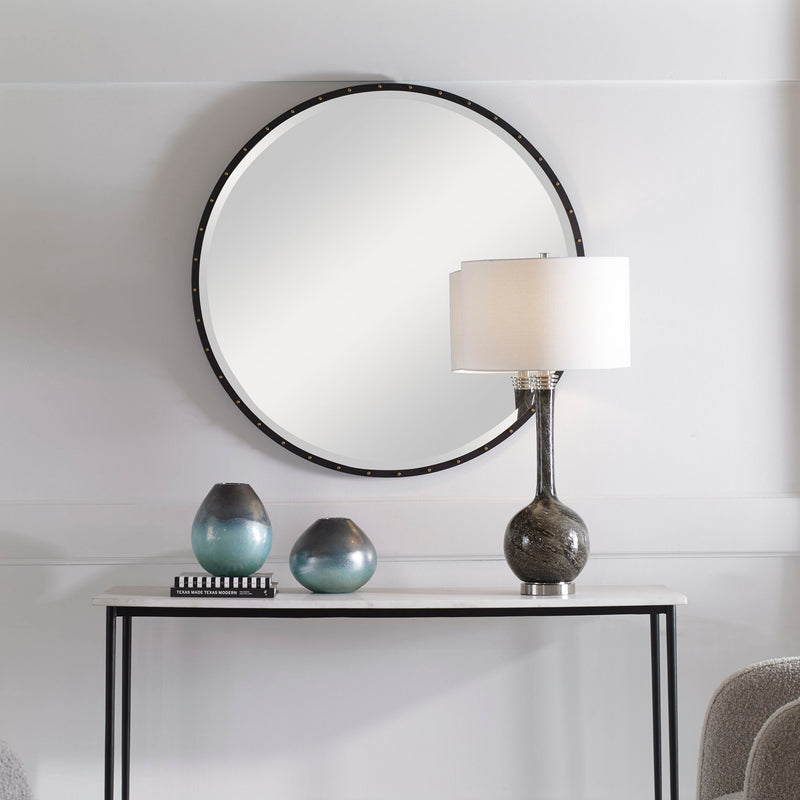 Black round wall mirror by Uttermost, featuring a sleek frame and reflective glass, perfect for modern home decor.