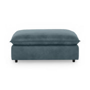 Classic Home Caplan upholstered ottoman with plush fabric and sturdy wooden legs, versatile for living room or seating area.