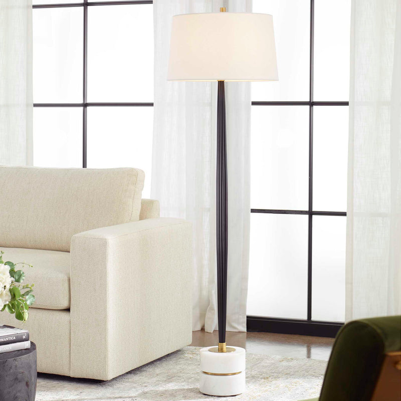 Black Miraz floor lamp by Uttermost, featuring a sleek modern design with a tall, elegant structure and a stylish lampshade.