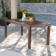 Dark brown acacia wood outdoor dining table with slatted top, from Noble House, designed for outdoor patio use.