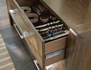 Brown Marxmore three-drawer nightstand with built-in charging station from Benchcraft, showing a sleek wooden finish with drawers.