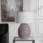 Uttermost Cyprien gray and white table lamp with a sleek modern design and a cylindrical shape.