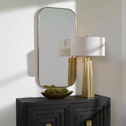 Uttermost Taft wall mirror with a sleek, modern frame, reflecting a stylish home decor setting.