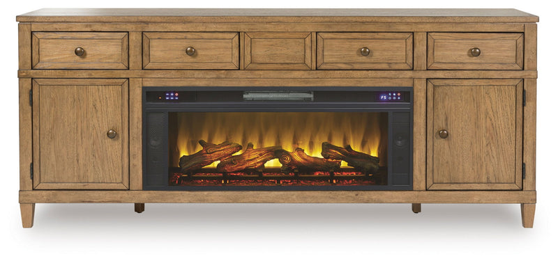 Sharlance 81-inch TV stand with electric fireplace from Signature Design by Ashley, featuring modern wood finish and built-in heating display.