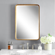 Uttermost Crofton wall mirror with antique gold finish, featuring a round frame and elegant design for sophisticated wall decor.