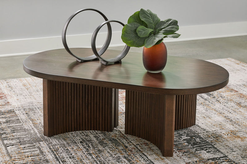 Korestone - Oval Cocktail Table - Dark Brown - R&R Furniture Gallery (Fountain Valley, CA)