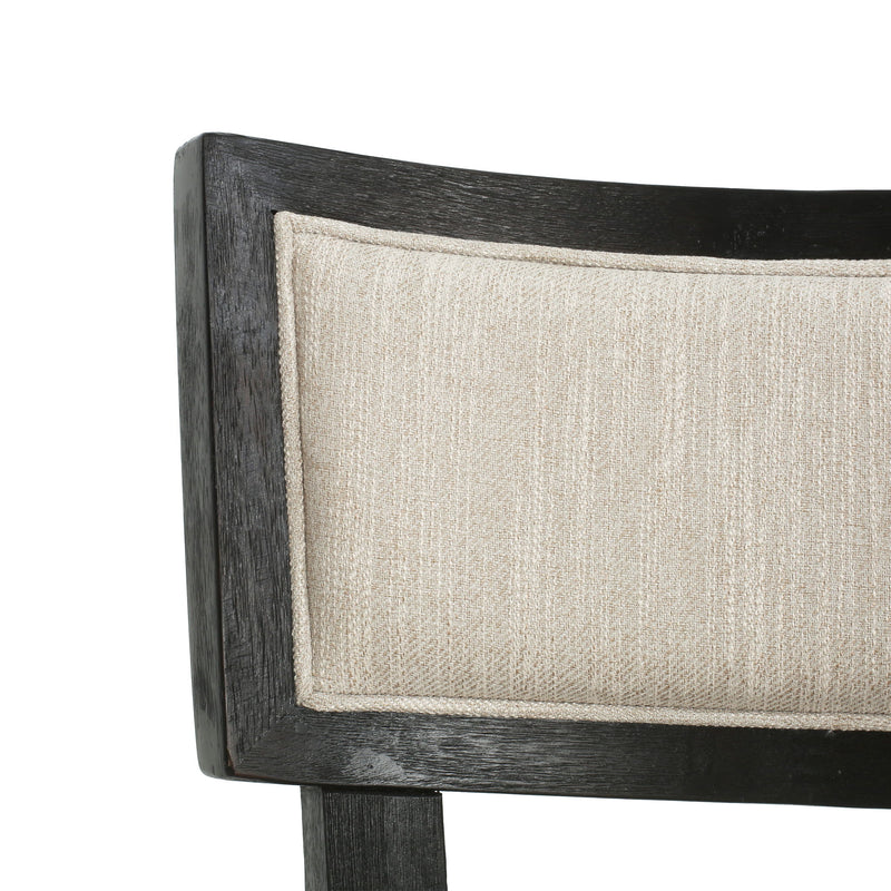 Noble House farmhouse style fabric upholstered side dining chairs set with wooden legs and cushioned seats.