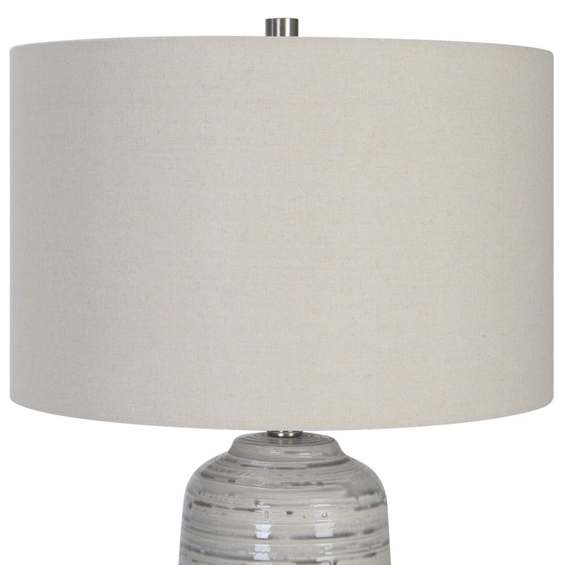 Uttermost Cyclone ivory table lamp with textured ceramic base and fabric shade, ideal for modern home decor.