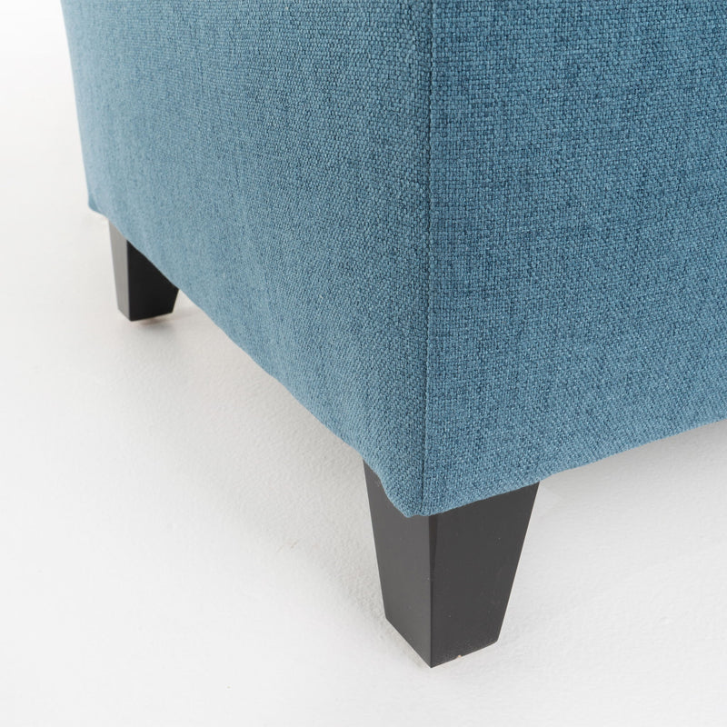 Noble House Juliana storage ottoman with birch wood legs, upholstered in neutral fabric, serving as a versatile seating and storage piece.