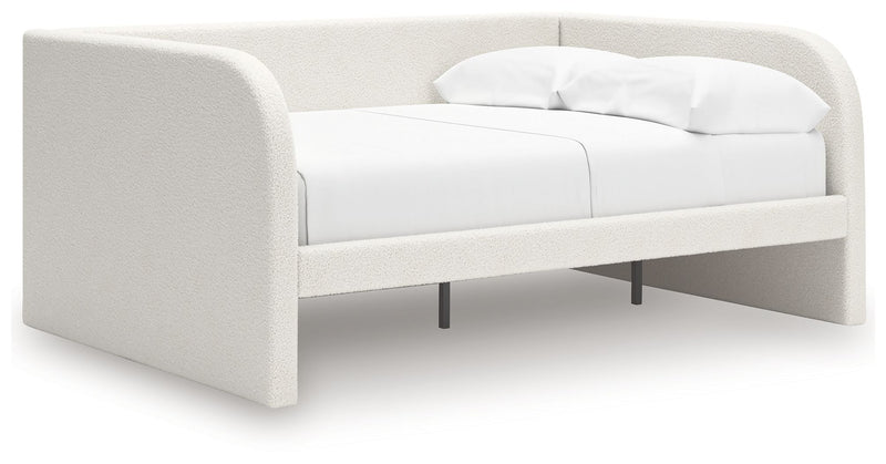 Signature Design by Ashley upholstered day bed with plush fabric and a modern frame, perfect for a stylish guest or lounging space.