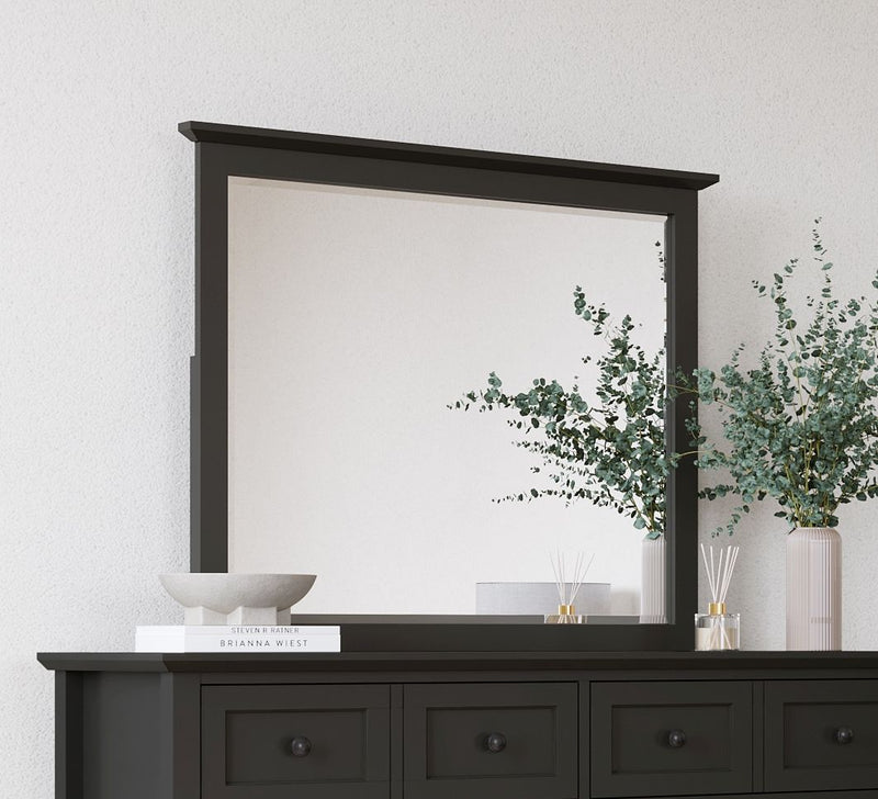 Modus Grace wall or dresser mirror in Raven Black, featuring a sleek rectangular frame and modern design, hanging on a wall.