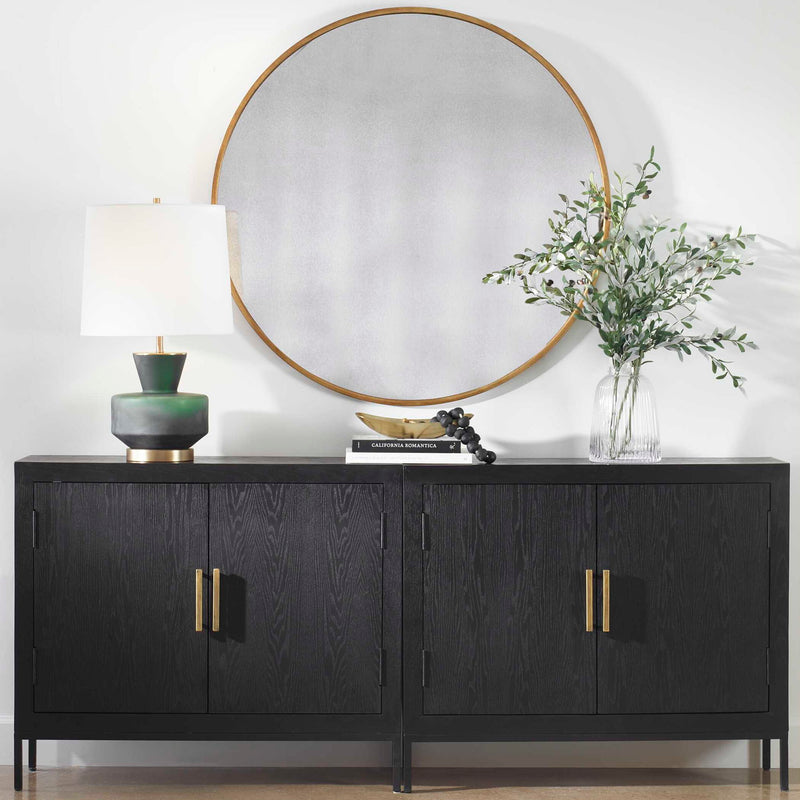 Round wall mirror by Uttermost featuring a sleek frame, ideal for modern home decor.