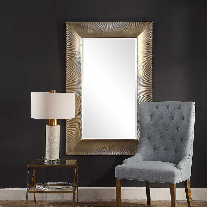 Large Valenton wall mirror by Uttermost featuring a champagne-colored frame with a sleek, modern design.