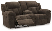 Comfortable reclining sofa from the Frohn living room set by Signature Design Ashley, showcasing plush cushions and reclining features.