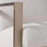 Contemporary beige accent arm chair by Uttermost featuring plush upholstery and sleek modern design.