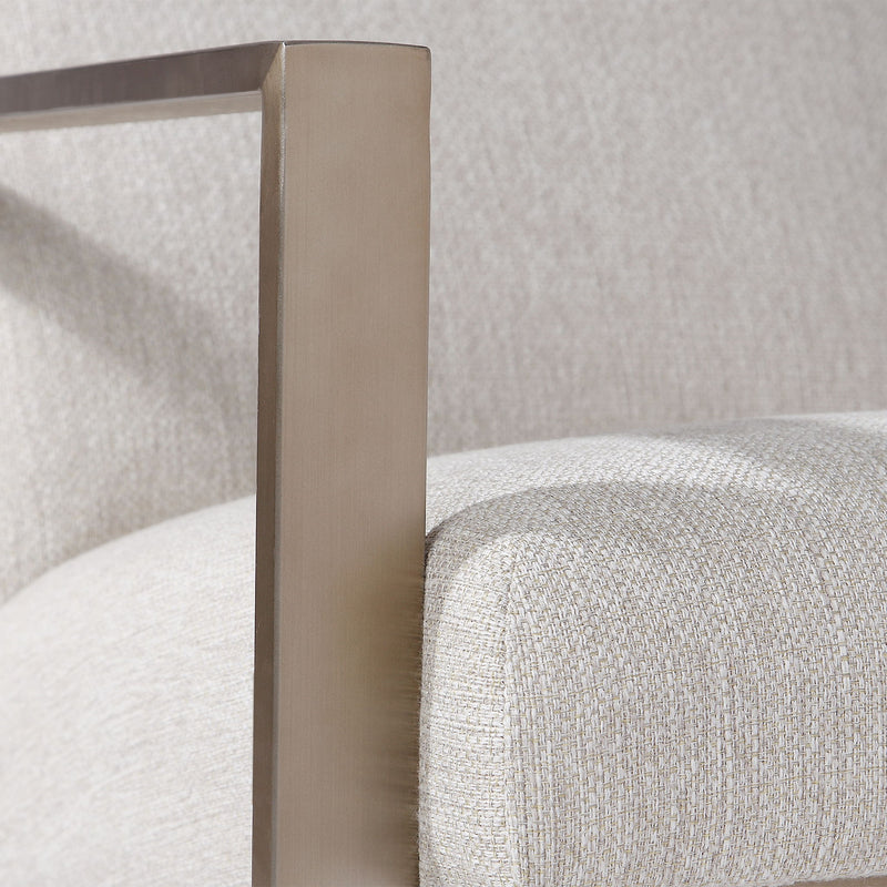 Contemporary beige accent arm chair by Uttermost featuring plush upholstery and sleek modern design.
