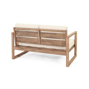 Noble House 4-piece acacia wood outdoor patio furniture set with coffee table, deep seating, beige cushions, for backyard porch or balcony.
