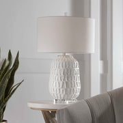 White textured Caelina table lamp by Uttermost featuring a modern design with a sleek finish and cylindrical shape.