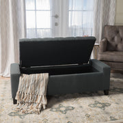 Dark gray Noble House storage ottoman with tufted top, serving as a functional and stylish contemporary storage solution.