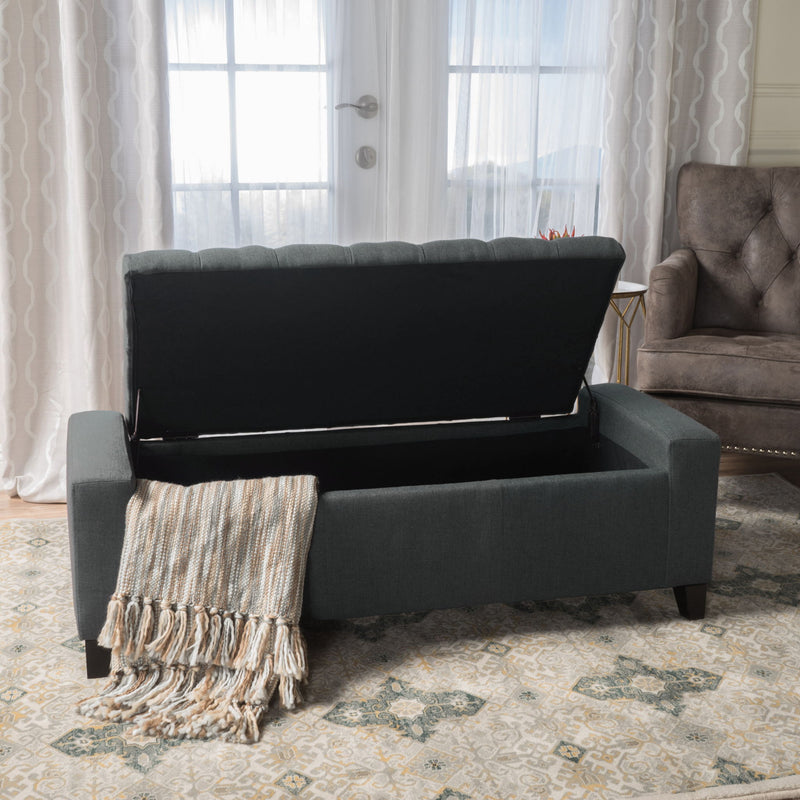 Dark gray Noble House storage ottoman with tufted top, serving as a functional and stylish contemporary storage solution.