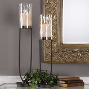 Black iron Durga candleholders set of 2 by Uttermost, featuring intricate iron work and candle cups for decorative lighting.