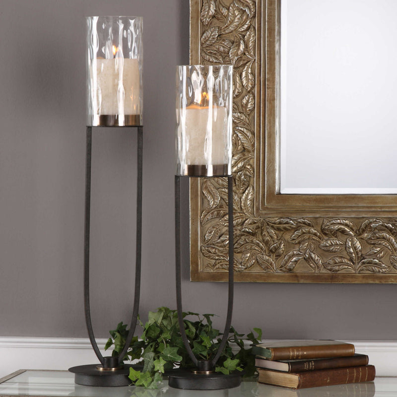 Black iron Durga candleholders set of 2 by Uttermost, featuring intricate iron work and candle cups for decorative lighting.