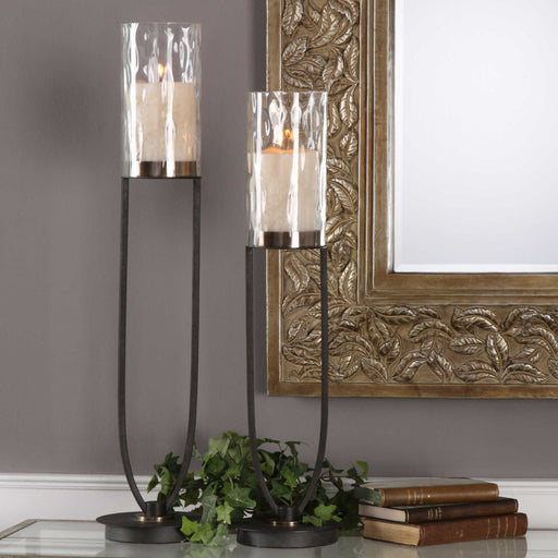 Black iron Durga candleholders set of 2 by Uttermost, featuring intricate iron work and candle cups for decorative lighting.