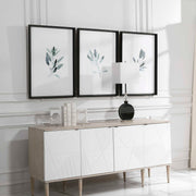 Set of three framed watercolor prints featuring simple sage green designs by Uttermost, with white backgrounds.