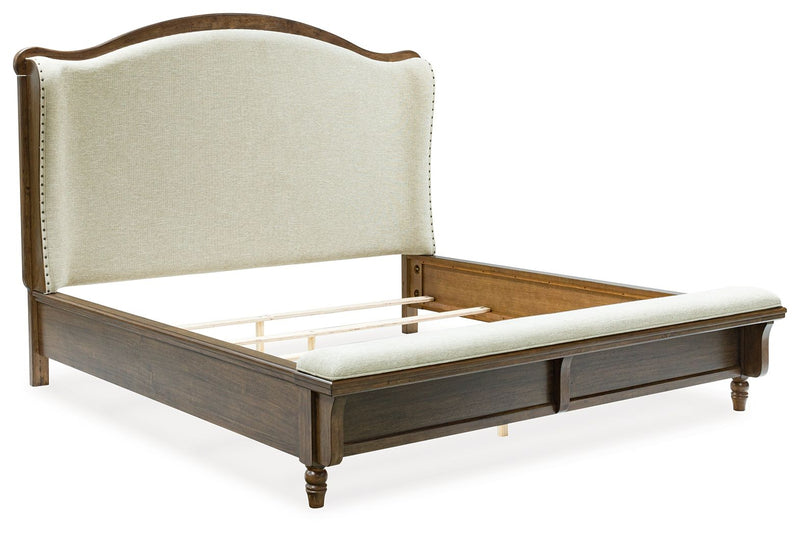 Benchcraft Sturlayne 6-piece panel bedroom set with bed frame, dresser, mirror, and nightstands in a modern bedroom setting.