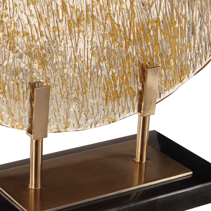 Uttermost Layan Art Glass Charger sculpture in gold featuring intricate glass design and artistic craftsmanship.