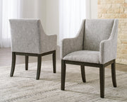Set of two Signature Design by Ashley beige and dark brown dining UPH arm chairs with cushioned seats and curved backs.