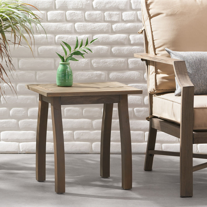 Noble House Kinesis outdoor side table with slatted top and wood frame, ideal for patio or garden seating areas.