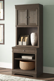 Janismore - Bookcase - Weathered Gray - R&R Furniture Gallery (Fountain Valley, CA)