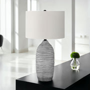 Modern gray and cream resin table lamp with sleek design, perfect for contemporary home décor.