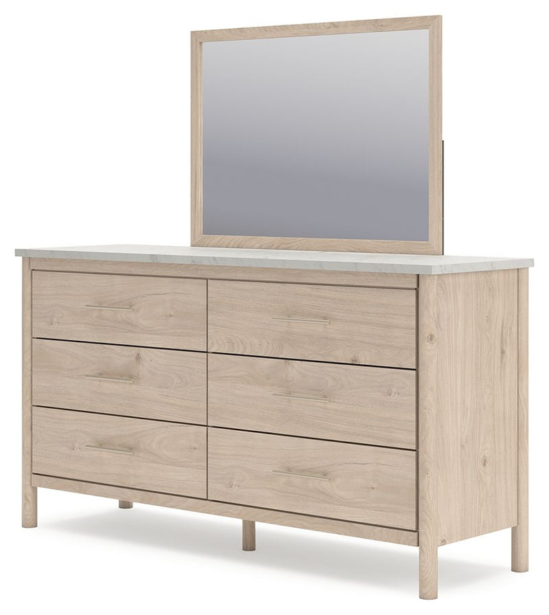 Signature Design by Ashley Cadmori six-drawer dresser with dark wood finish and sleek metal handles.